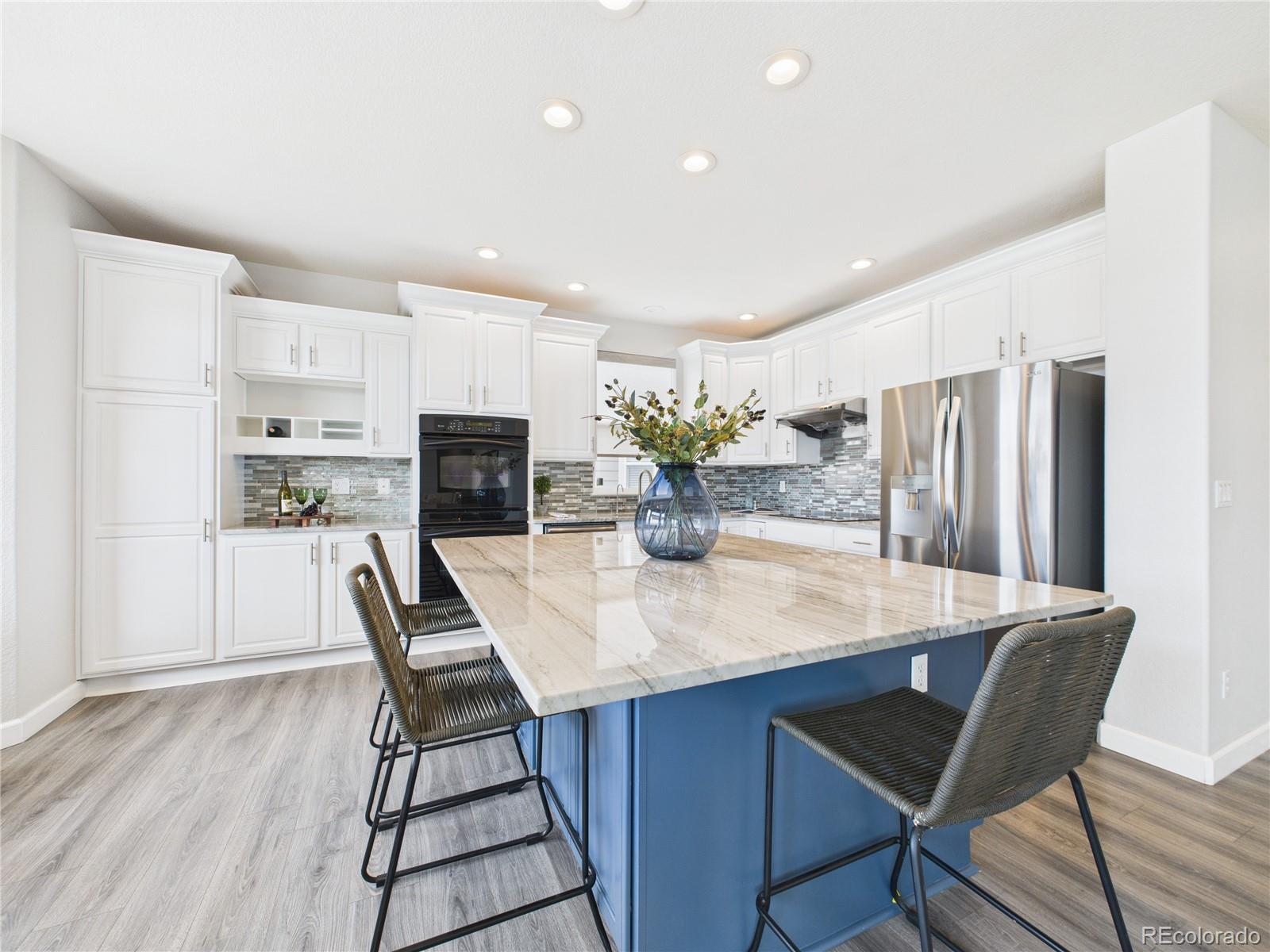 10501 Wagon Highlands Ranch Highlands Ranch, CO 80130 - Photo 11 of 50 a dining room with furniture and wooden floor