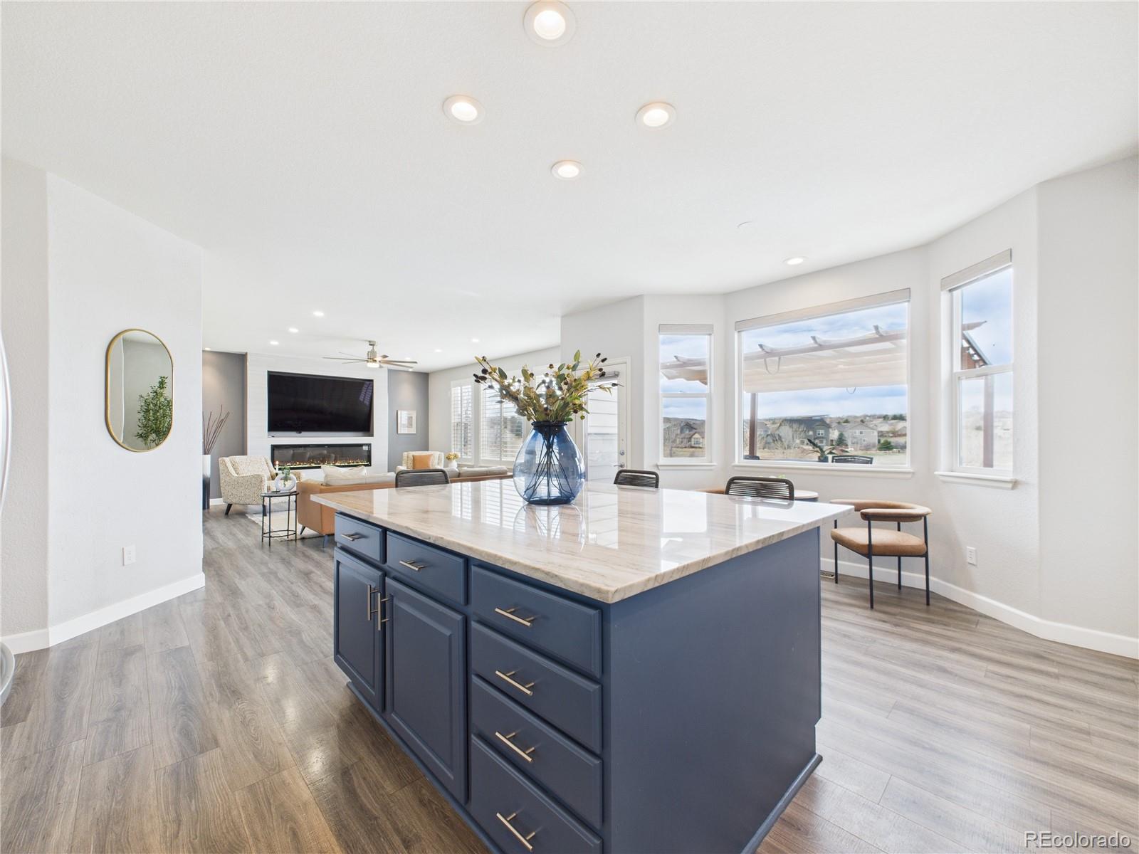 10501 Wagon Highlands Ranch Highlands Ranch, CO 80130 - Photo 13 of 50 a kitchen with kitchen island and view living room