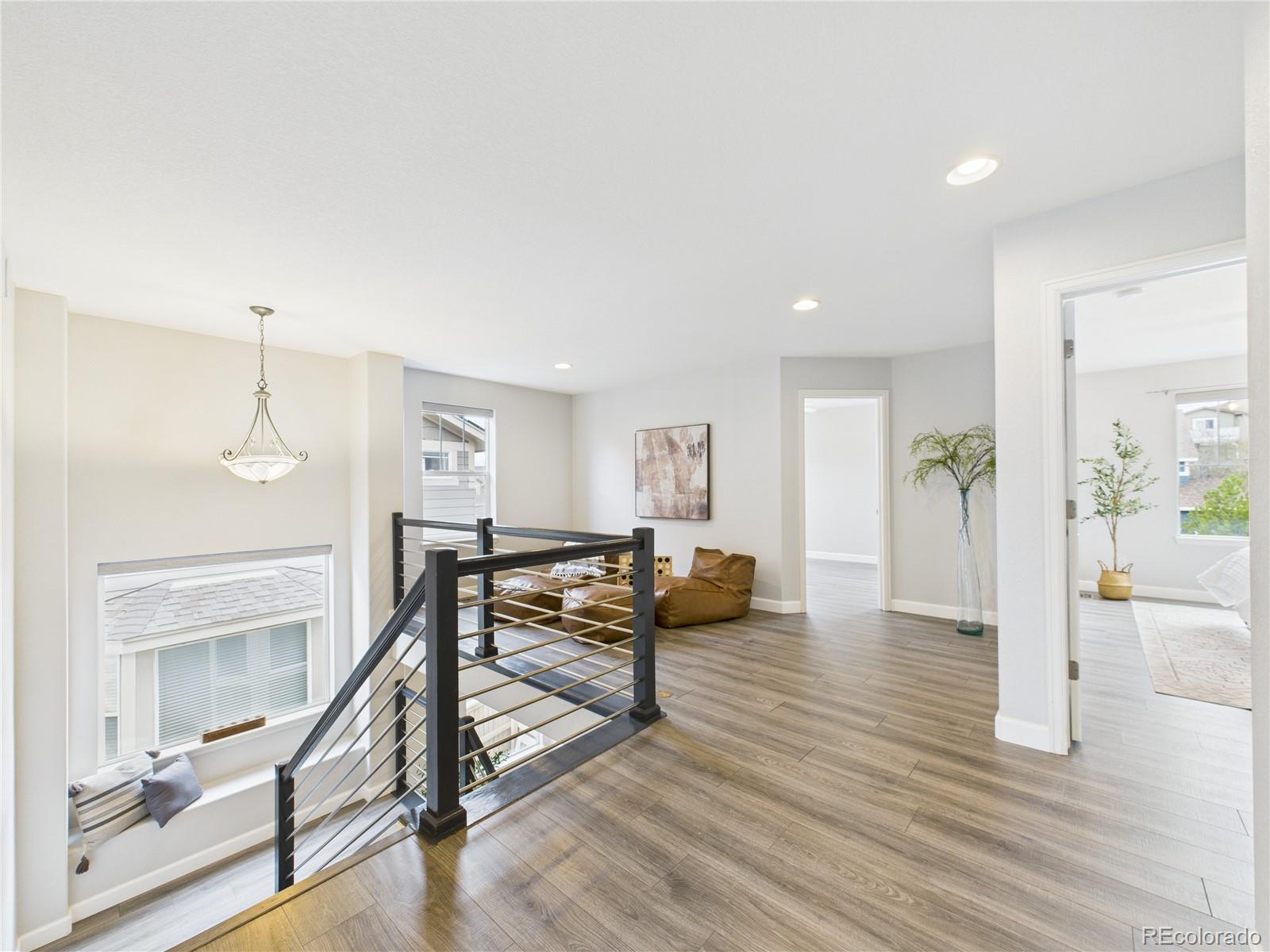 10501 Wagon Highlands Ranch Highlands Ranch, CO 80130 - Photo 17 of 50 a view of a livingroom with furniture and wooden floor