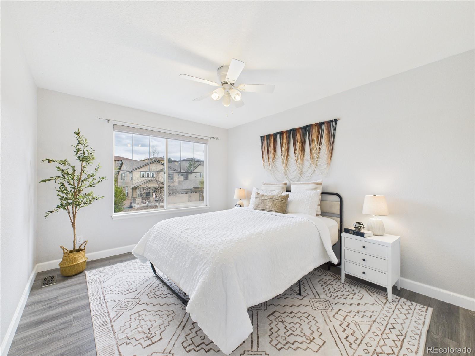 10501 Wagon Highlands Ranch Highlands Ranch, CO 80130 - Photo 18 of 50 a bedroom with a large bed and a chandelier
