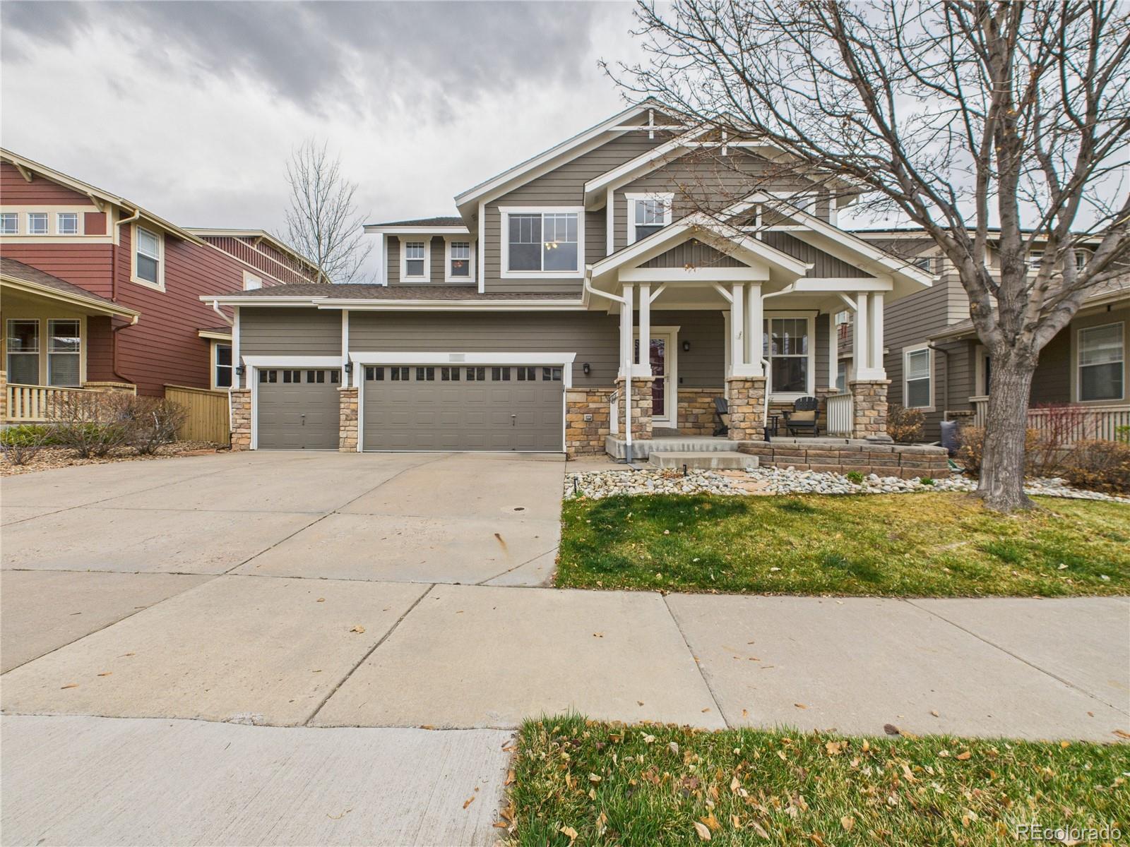 10501 Wagon Highlands Ranch Highlands Ranch, CO 80130 - Photo 2 of 50 a front view of a house with garden and trees