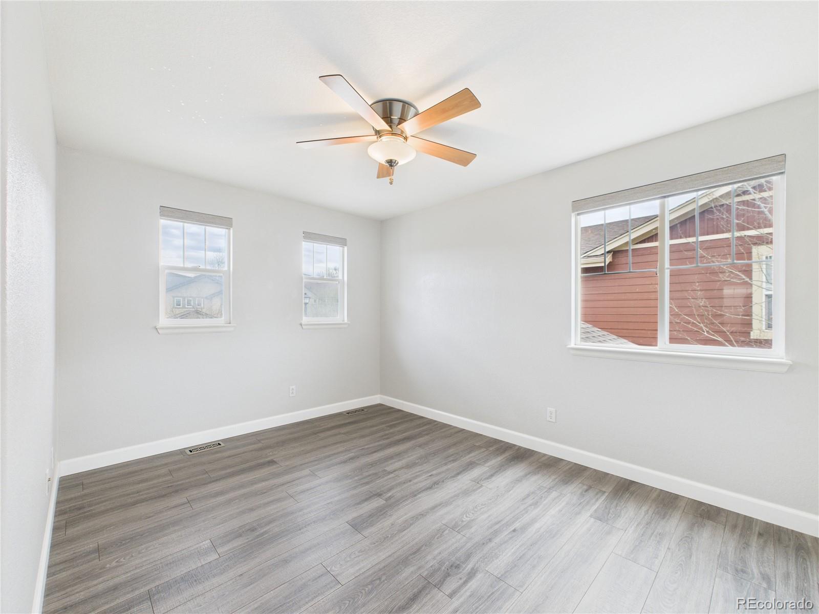 10501 Wagon Highlands Ranch Highlands Ranch, CO 80130 - Photo 21 of 50 a view of an empty room with wooden floor and a window