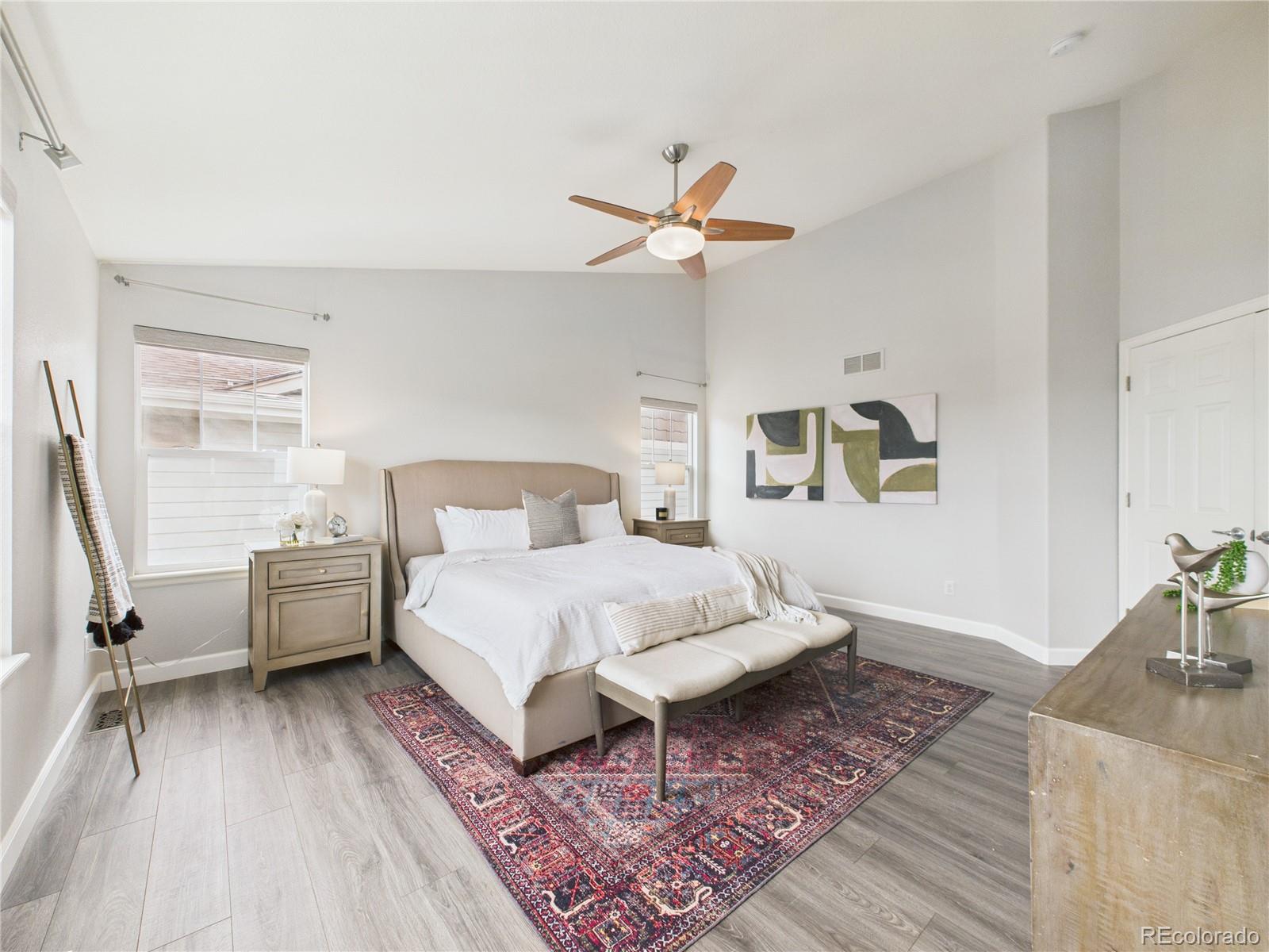 10501 Wagon Highlands Ranch Highlands Ranch, CO 80130 - Photo 26 of 50 a spacious bedroom with a bed and a chandelier