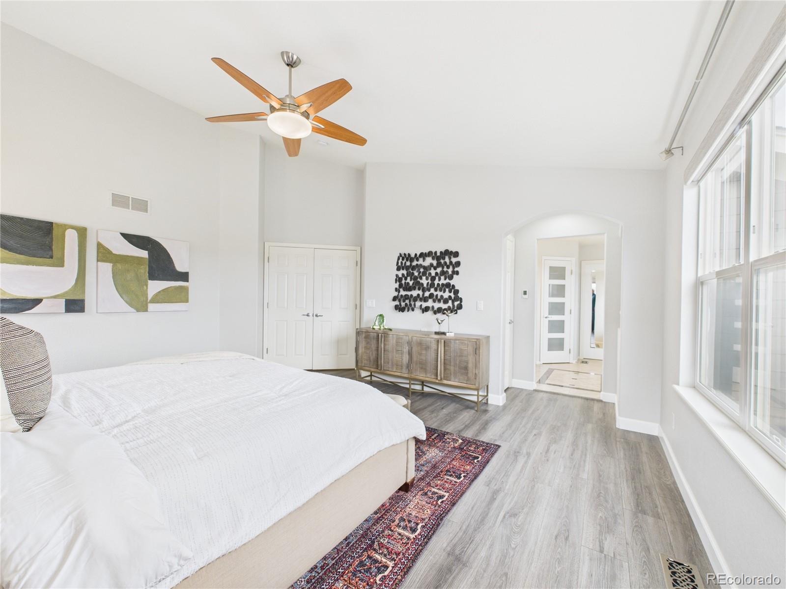 10501 Wagon Highlands Ranch Highlands Ranch, CO 80130 - Photo 27 of 50 a bedroom with a large bed a chandelier and a window