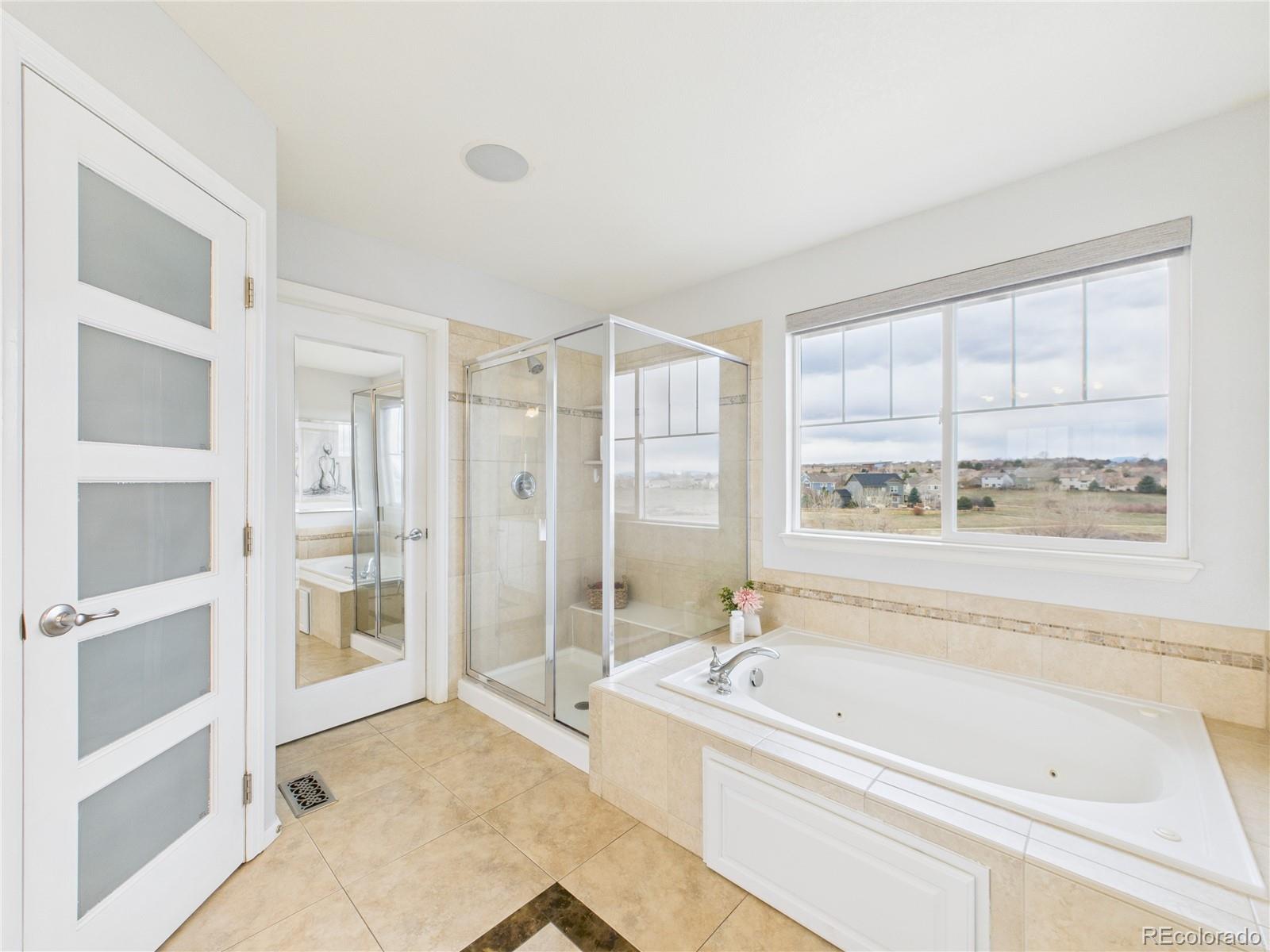 10501 Wagon Highlands Ranch Highlands Ranch, CO 80130 - Photo 29 of 50 a spacious bathroom with a tub and shower