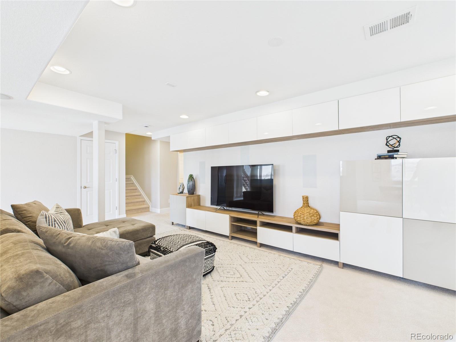 10501 Wagon Highlands Ranch Highlands Ranch, CO 80130 - Photo 33 of 50 a living room with furniture and a flat screen tv