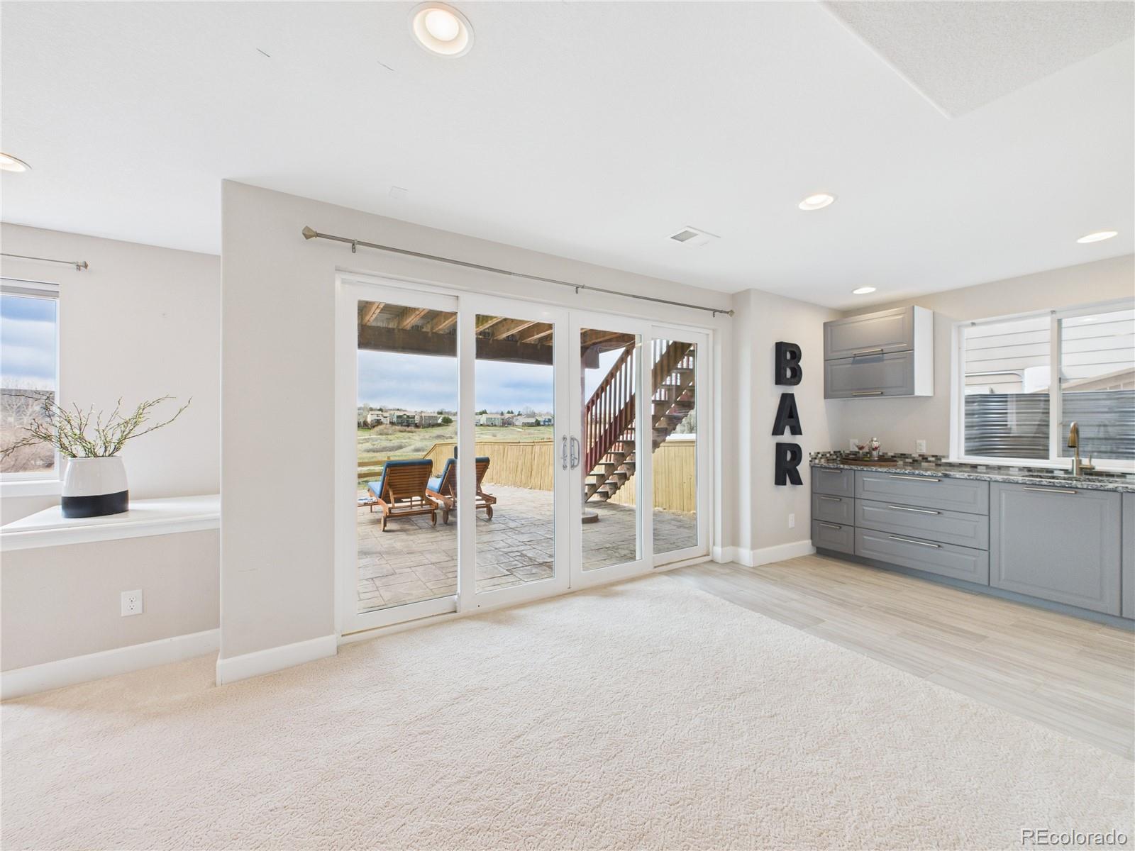 10501 Wagon Highlands Ranch Highlands Ranch, CO 80130 - Photo 36 of 50 a large white kitchen with refrigerator and cabinets