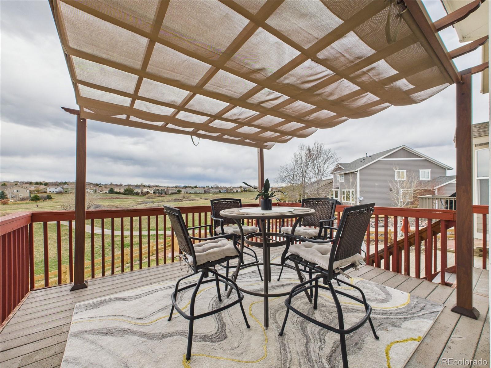 10501 Wagon Highlands Ranch Highlands Ranch, CO 80130 - Photo 39 of 50 a view of a chairs and table in the patio