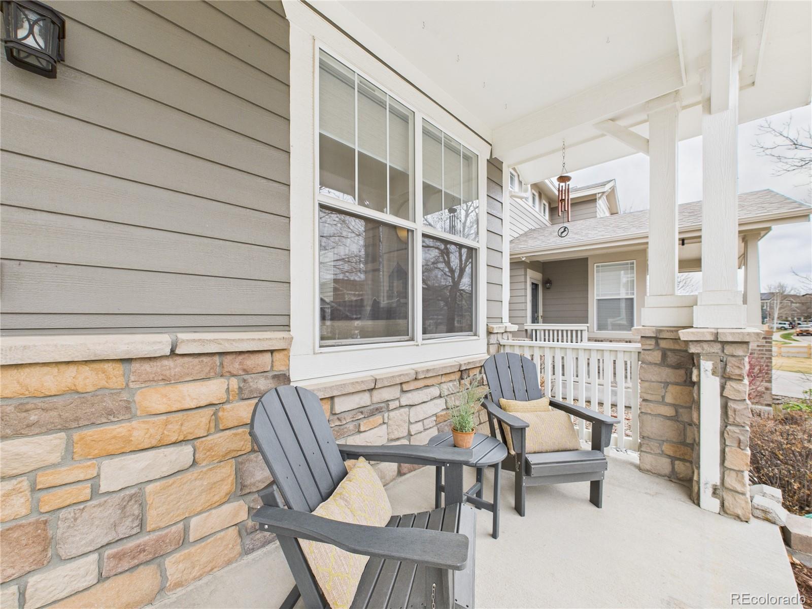 10501 Wagon Highlands Ranch Highlands Ranch, CO 80130 - Photo 4 of 50 a view of a chair and table in the back yard of the house