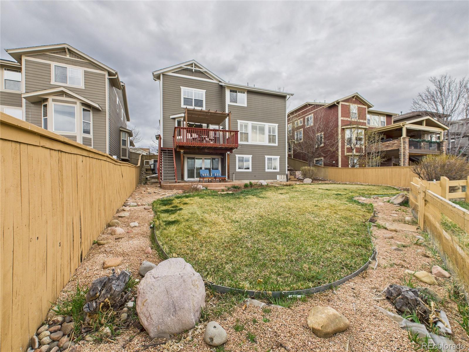 10501 Wagon Highlands Ranch Highlands Ranch, CO 80130 - Photo 43 of 50 a view of a living room and a chandelier