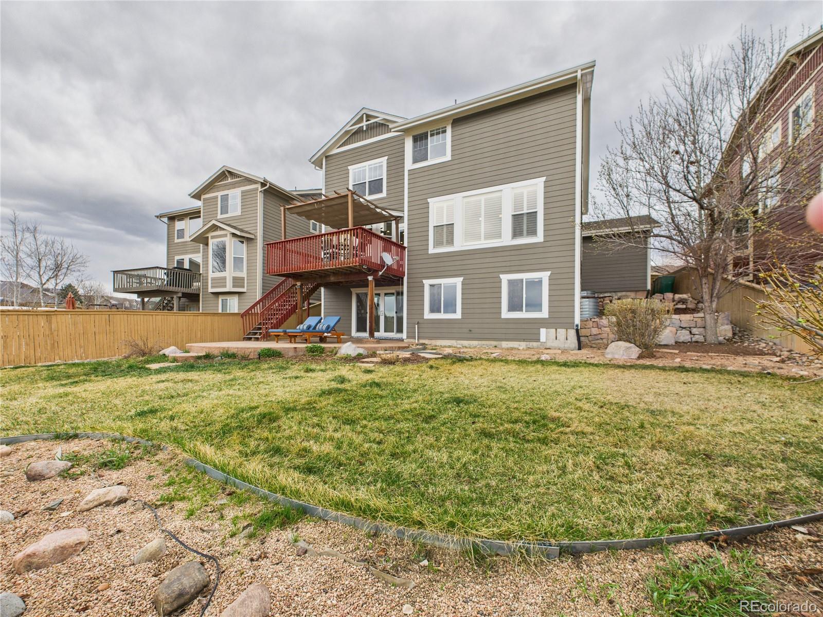 10501 Wagon Highlands Ranch Highlands Ranch, CO 80130 - Photo 44 of 50 a front view of a house with a yard