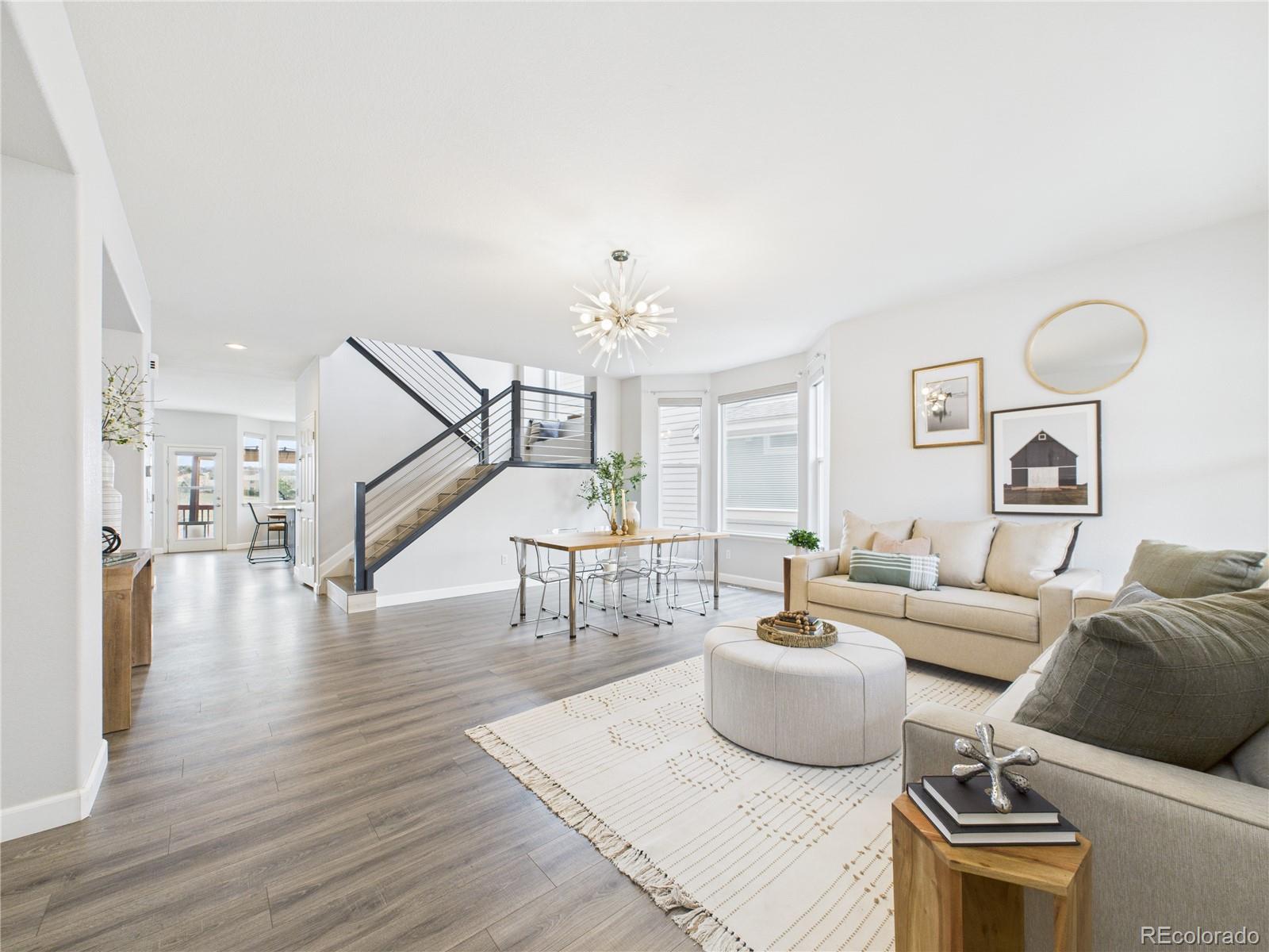 10501 Wagon Highlands Ranch Highlands Ranch, CO 80130 - Photo 5 of 50 a living room with furniture and a wooden floor