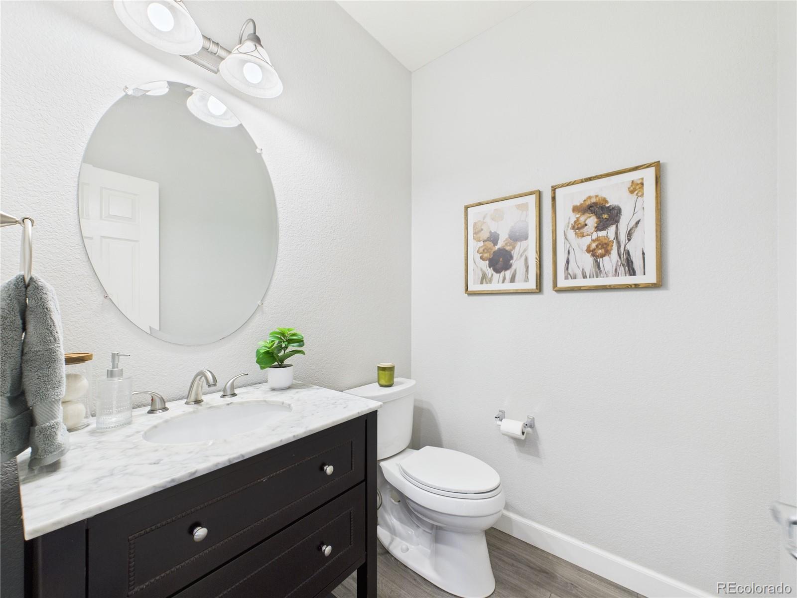 10501 Wagon Highlands Ranch Highlands Ranch, CO 80130 - Photo 9 of 50 a bathroom with a toilet a sink and mirror