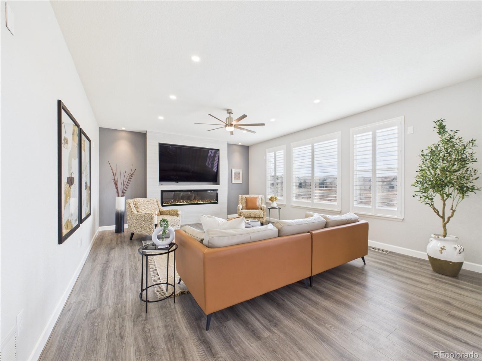 10501 Wagon Highlands Ranch Highlands Ranch, CO 80130 - Photo 10 of 50 a living room with furniture and a flat screen tv