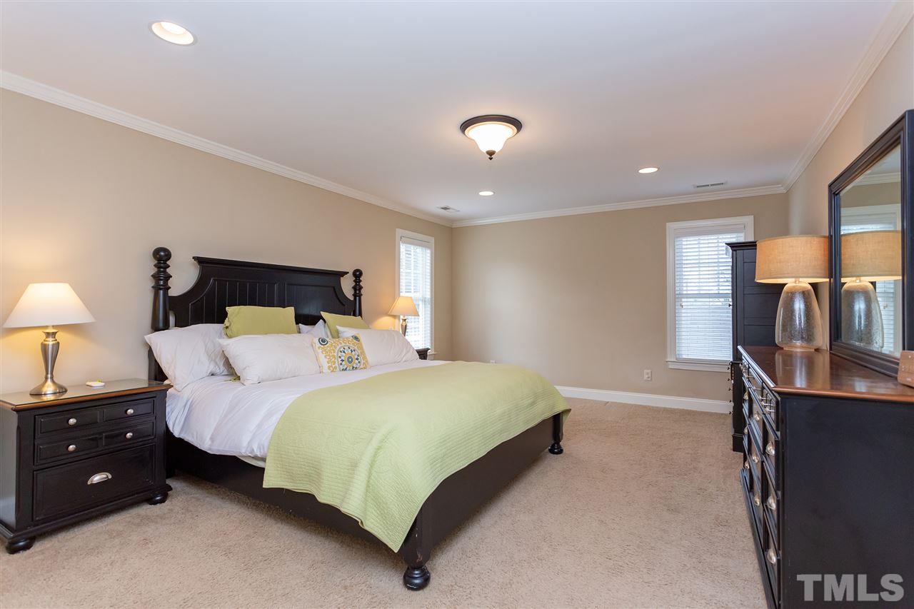 1907 Carroll Drive Raleigh, NC 27608 - Photo 14 of 30 a bedroom with a bed a lamp and a large window