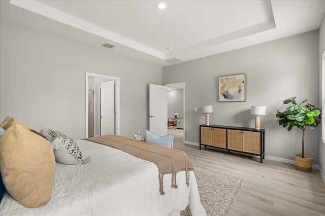 a bedroom with a bed and painting on the wall