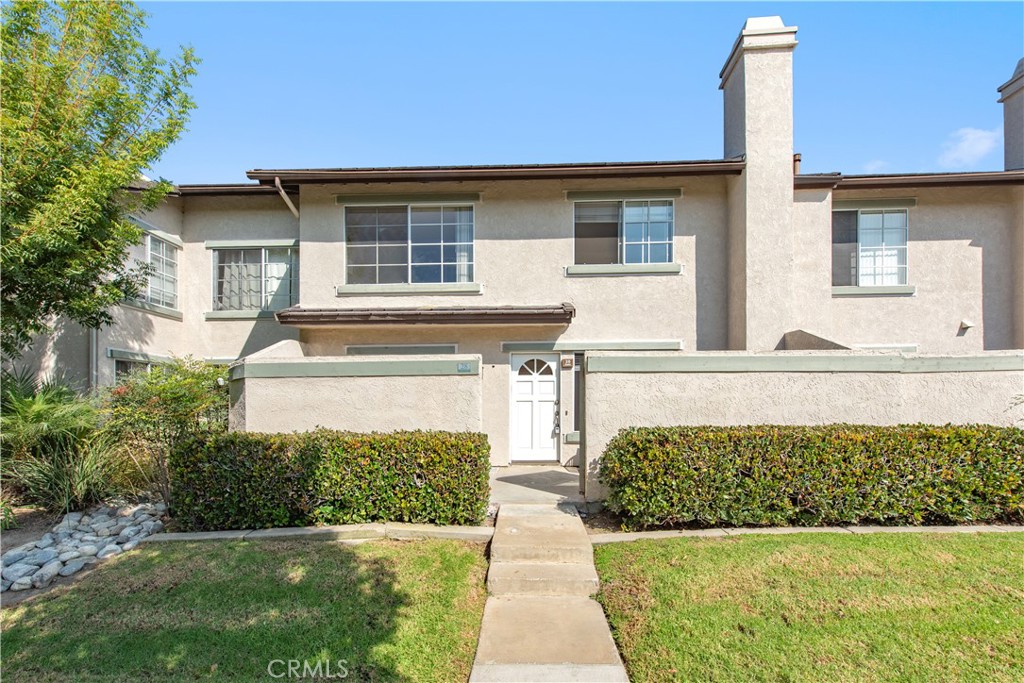 28 Exeter, Unit 19 Irvine, CA 92612 - Photo 1 of 35 a front view of a house with garden