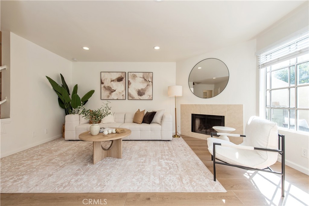 28 Exeter, Unit 19 Irvine, CA 92612 - Photo 13 of 35 a living room with furniture and a fireplace