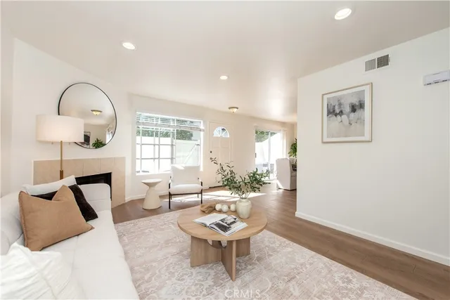 a living room with furniture a window and a potted plant
