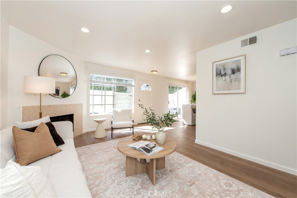 28 Exeter, Unit 19 Irvine, CA 92612 - Photo 15 of 35 a living room with furniture a window and a potted plant
