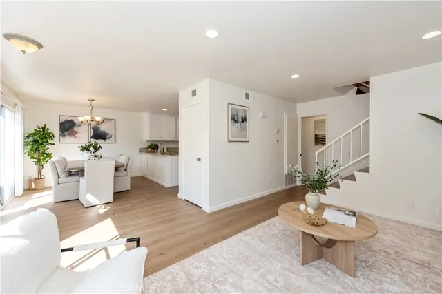 a living room with furniture and a dining room