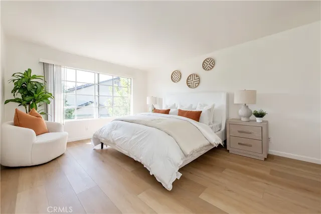 a bedroom with a large bed and a large window