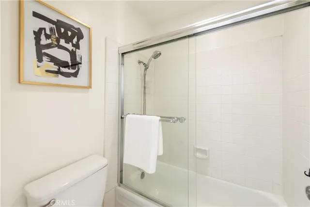 a bathroom with a shower and a toilet