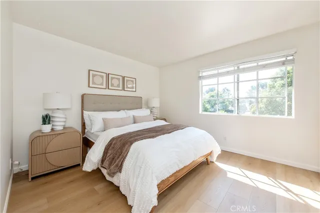 a bedroom with a bed and a large window