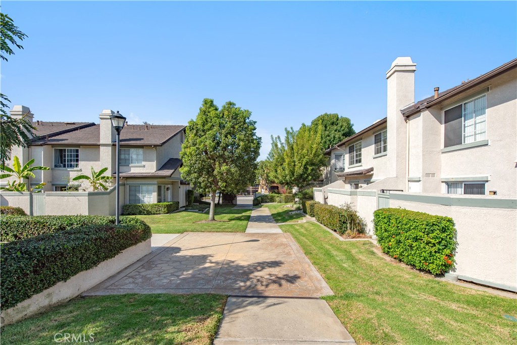 28 Exeter, Unit 19 Irvine, CA 92612 - Photo 27 of 35 a front view of a house with garden