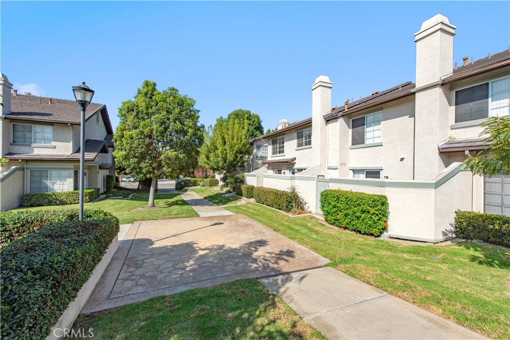 28 Exeter, Unit 19 Irvine, CA 92612 - Photo 28 of 35 a view of a front of a house with a yard