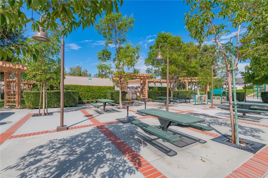 28 Exeter, Unit 19 Irvine, CA 92612 - Photo 32 of 35 a view of a swimming pool with a patio
