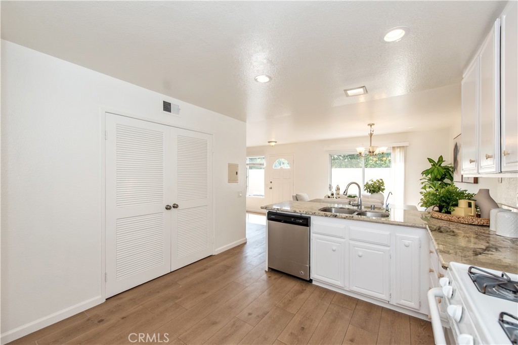 28 Exeter, Unit 19 Irvine, CA 92612 - Photo 9 of 35 a kitchen with a sink cabinets and wooden floor