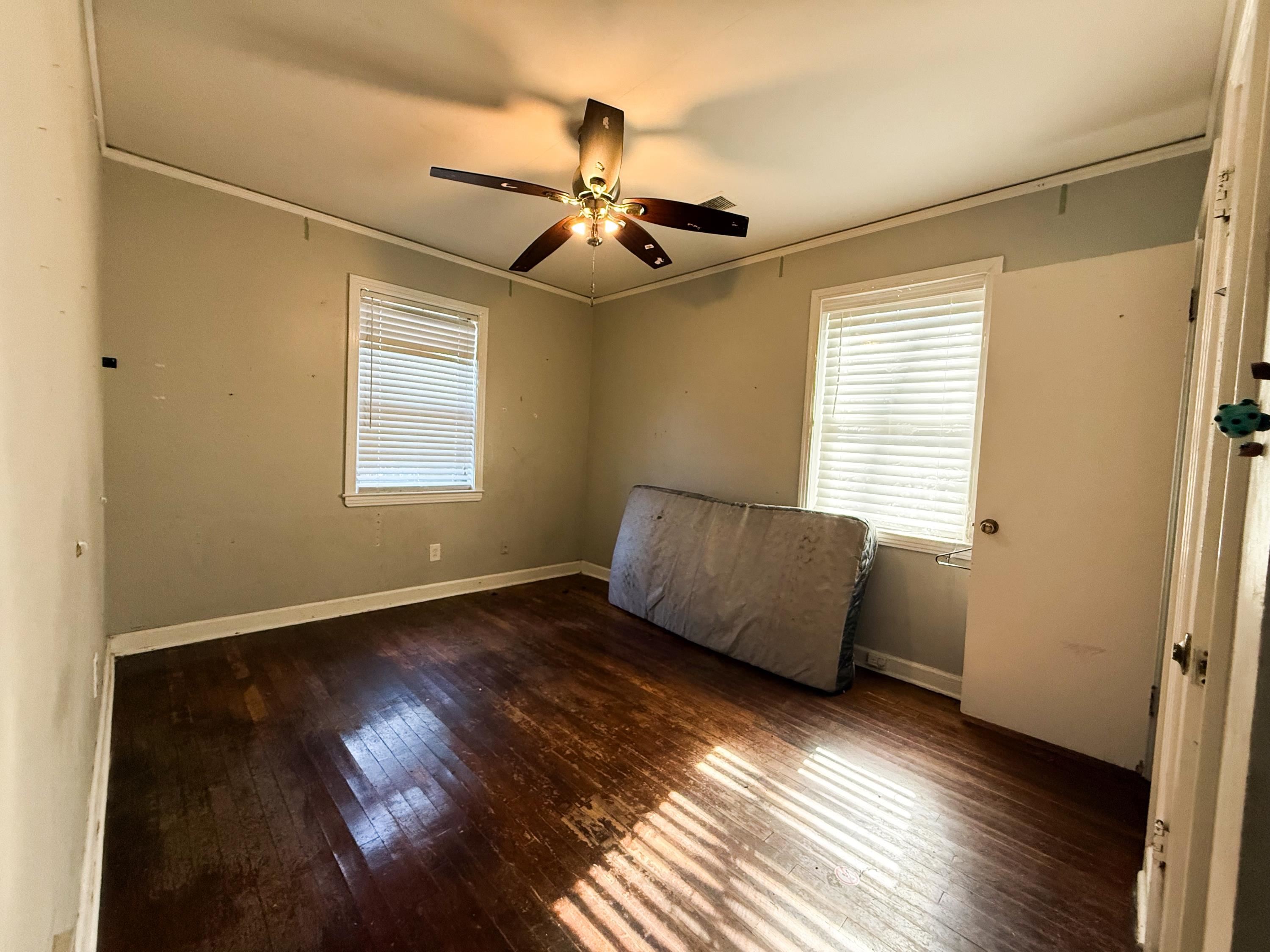 1027 Waring Road Memphis, TN 38122 - Photo 12 of 14 Unfurnished bedroom with dark wood-style floors and a ceiling fan