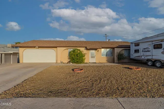 a view of a house with a yard and sitting area