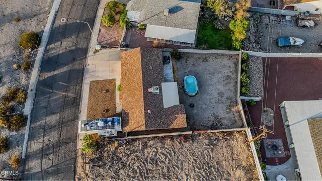 a front view of a house with a yard and mountain view