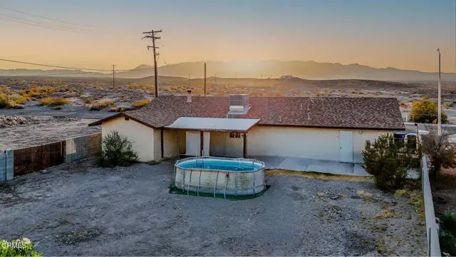 an aerial view of ocean and residential houses with outdoor space