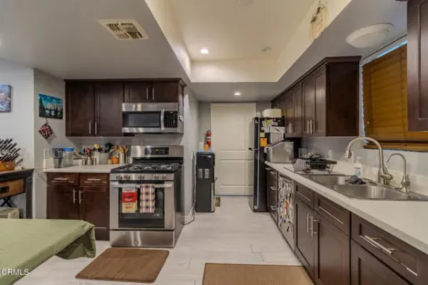 a living room with furniture a kitchen view and a kitchen view