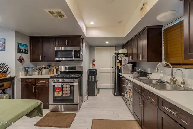 a living room with furniture a kitchen view and a kitchen view