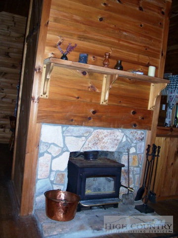 105 Misty Ridge Road Millers Creek, NC 28651 - Photo 16 of 18 a room with fireplace and a wooden floor