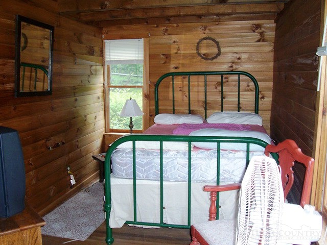 105 Misty Ridge Road Millers Creek, NC 28651 - Photo 18 of 18 a bedroom with a bed and a window
