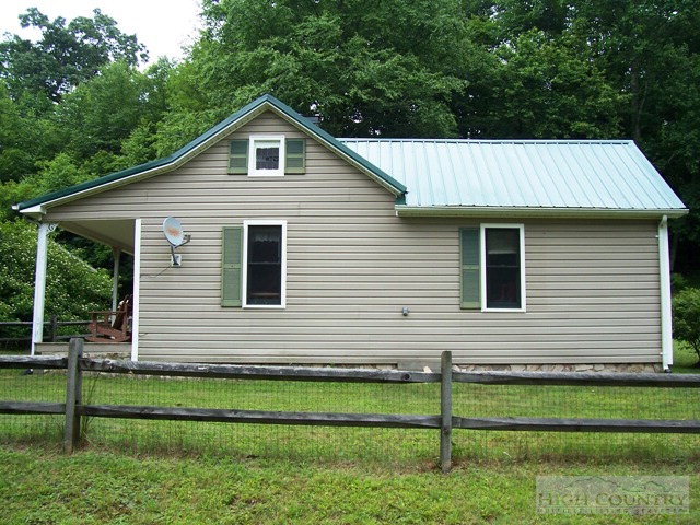 105 Misty Ridge Road Millers Creek, NC 28651 - Photo 2 of 18 a front view of a house with a garden