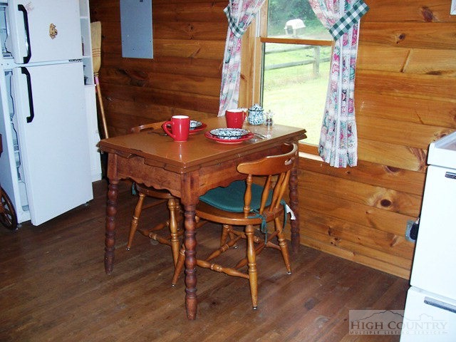 105 Misty Ridge Road Millers Creek, NC 28651 - Photo 3 of 18 a view of a dining room with furniture and wooden floor