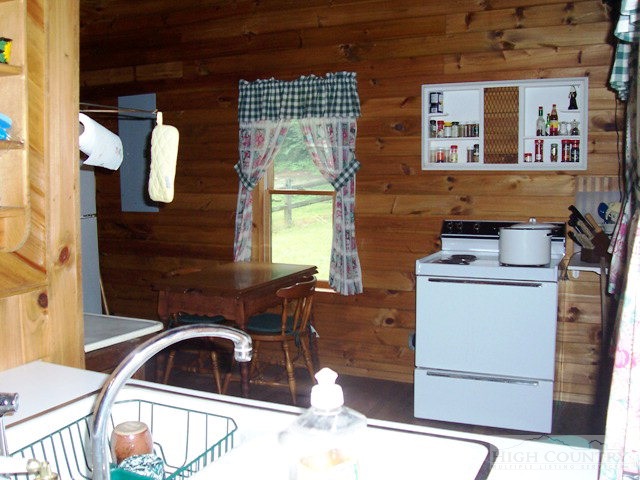 105 Misty Ridge Road Millers Creek, NC 28651 - Photo 4 of 18 a kitchen with a sink cabinets and window