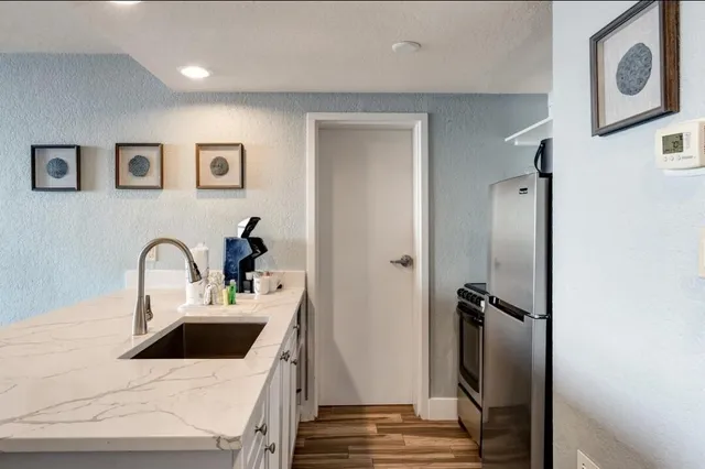 a kitchen with a sink and a refrigerator