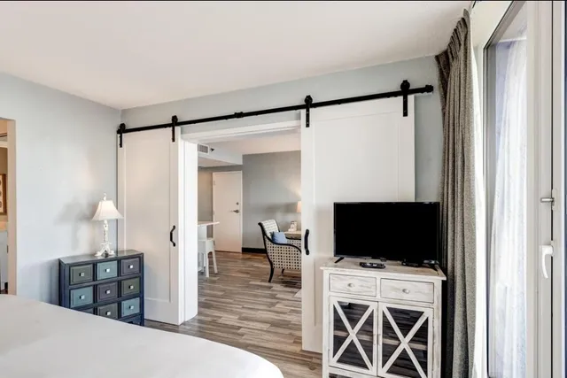 a bedroom with furniture and a flat screen tv