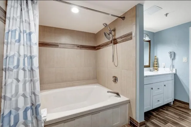 a bathroom with a bathtub and a shower