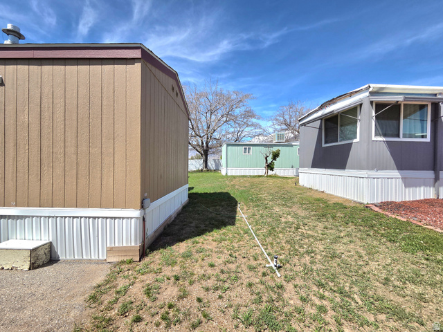 597 North State Street, Unit 67 Orem, UT 84057 - Photo 22 of 23 View of grassy yard featuring an outdoor structure