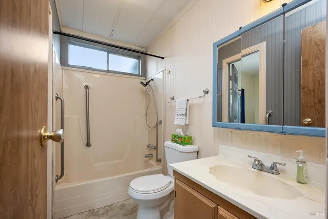 a bathroom with a sink toilet and shower