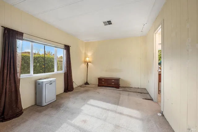 a view of a room that has a large window and bed