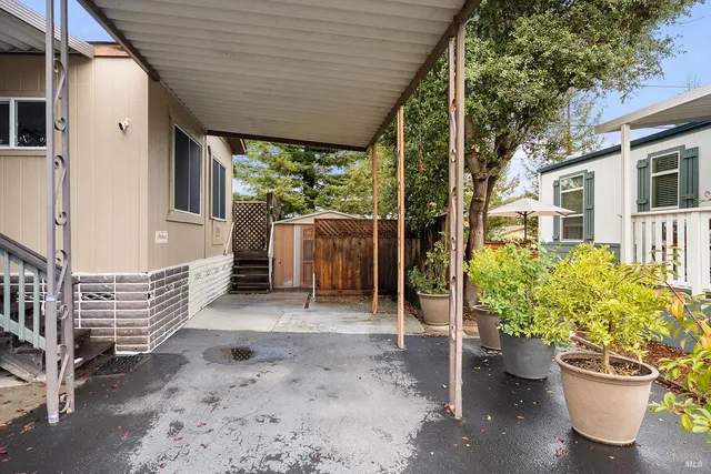 a wooden bench sitting in front of a house